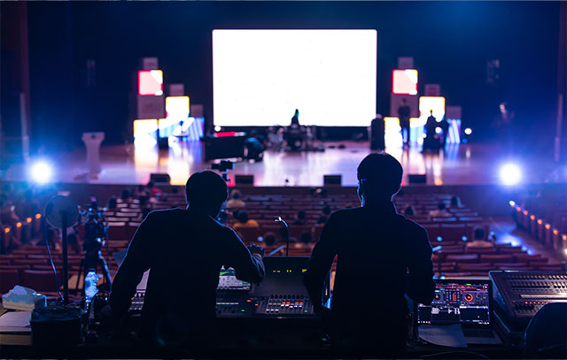 View of two stage technicians and a large stage