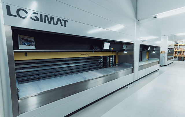 A white wall with LOGIMAT inscription and a shelf built into it