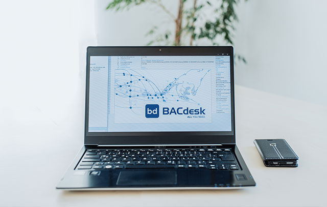 A laptop with the BACdesk logo