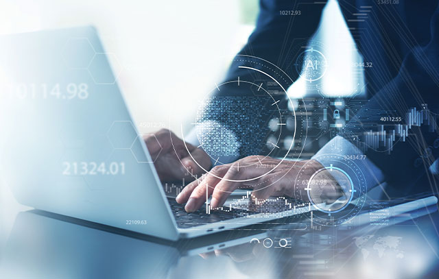 Two hands lie on laptop keyboard