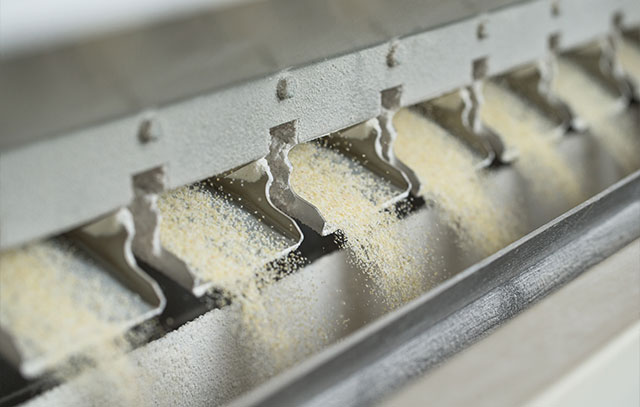 6 outputs of a grinder from which flour is scattered