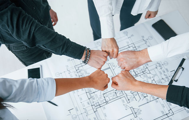 A group of people put their fist together to form a circle