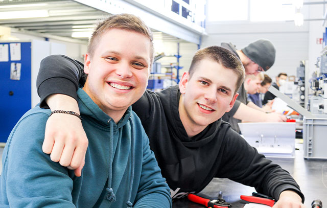 Two boys sitting at a workbench