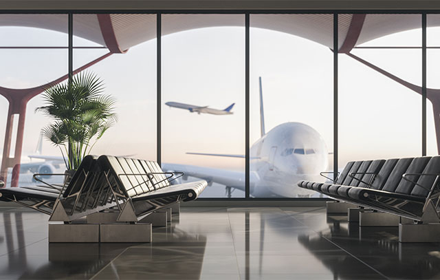 Waiting hall of an airport with glass front, in front of it an airplane