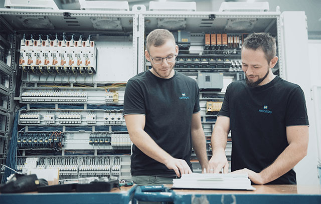 Two men stand in the production hall